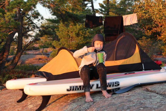 Nathan, his paddle board and tent on his Georgian Bay expedition